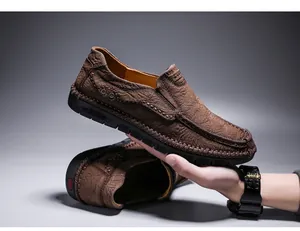 Detailweergave van handgestikte bruine leren loafers met textuurafwerking en een zachte zool