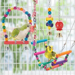 Detail showing colorful parrot toy set with swing, wood ladder and metal bells in bird cage.