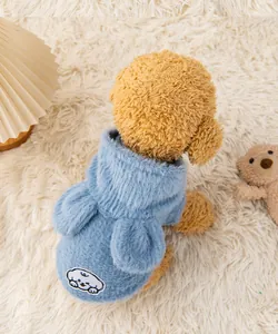 Macro view of blue fleece pet hoodie featuring a cute cartoon animal patch on the back