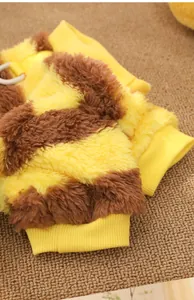 Close-up of soft bee-style dog fleece suit showing yellow and brown striped texture