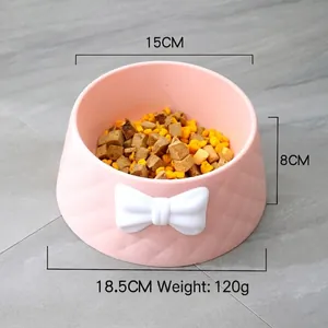 Macaron pink pet bowl featuring a white bowknot and diamond pattern for dogs and cats