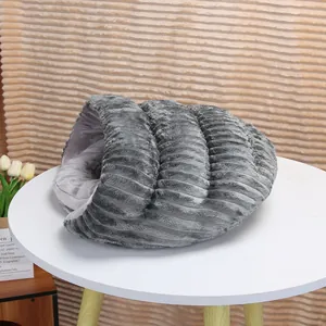 Detailed view of a cozy grey plush slipper-shaped cat bed on a white table scene
