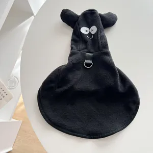 Close-up of black fleece Halloween pet cloak with funny cartoon eyes and D-ring