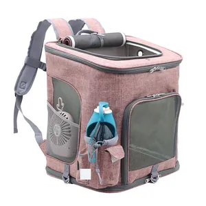 Detailed view of the pink pet backpack with side pockets holding a fan and bottle