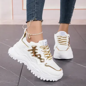 Stylish white chunky sneakers for women featuring golden fishbone mesh design details