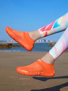 Vibrant orange five-finger water shoes for outdoor beach activities and swimming.