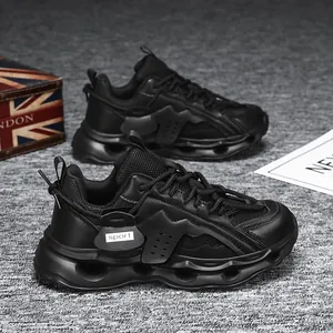 Close-up side view of all-black women's chunky sneakers featuring a hollowed-out sole.