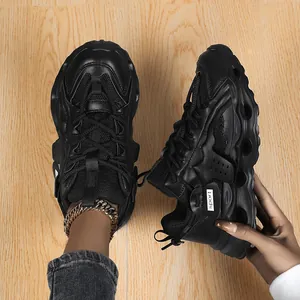 Close-up detail of stylish black chunky sneakers with thick sculpted soles and mesh upper