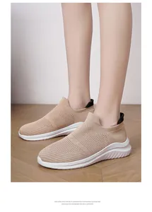 Close-up of beige breathable knit sock sneakers with lightweight white EVA sole