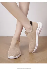 On-foot view of lightweight beige knitted sneakers showing breathable mesh texture