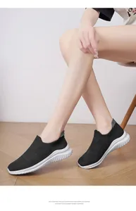 Close-up of black breathable knit sock shoes with a white lightweight EVA foam sole