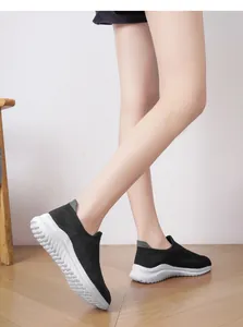 Close-up side view of black breathable knit sock sneakers with thick white textured sole