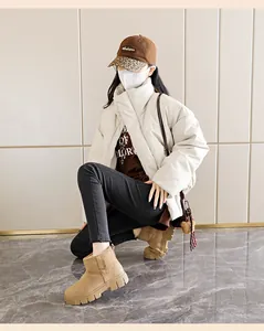 Stylish women's khaki suede snow boots with thick soles shown in a lifestyle setting