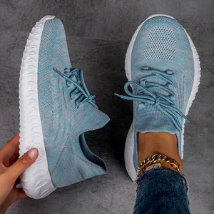 Macro view of light blue flyknit breathable sneakers with white textured sole