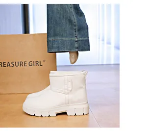 Detailed side view of white suede snow boots with thick non-slip soles and warm lining.