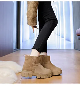Side detail of warm suede snow boots with thick anti-slip sole and plush fur lining.