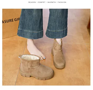Close-up of brown suede snow boots with thick sole and warm faux fur lining
