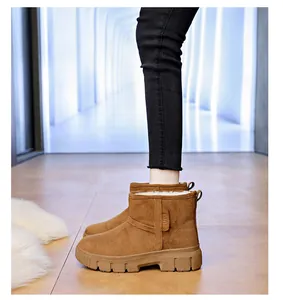 Detailed side view of brown suede snow boots with thick white faux fur lining and thick sole
