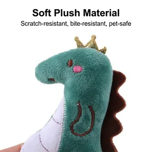 Detailed view of green plush dinosaur cat toy with golden crown for interactive pet play