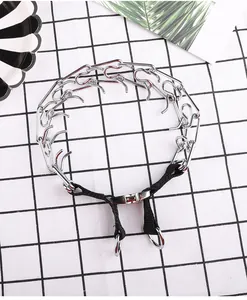 Top-down view of metal prong training collar with adjustable nylon strap.