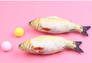 Realistic plush fish catnip toy with detailed scale printing on pink background.