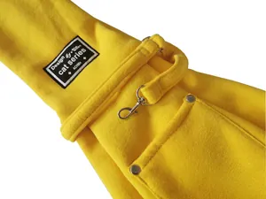 Close-up detail of yellow fleece pet carrier bag with metal clasp and brand label