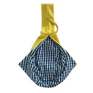 Yellow pet sling carrier with black and white checkered lining and metal safety clip
