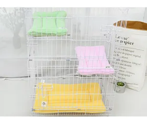 Detail view of macaron-colored pet cage mats arranged on three platform levels