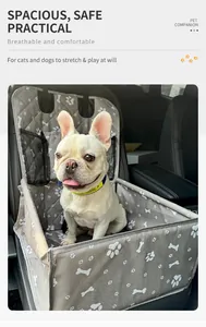 A French Bulldog sitting comfortably in a foldable grey pet car seat carrier inside a vehicle