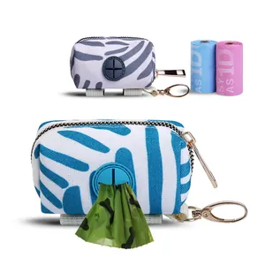 Detailed view of canvas dog waste bag dispenser pouch with carabiner and refill rolls