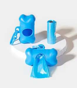 Close-up of blue bone-shaped pet poop bag dispenser and refill roll on white stand
