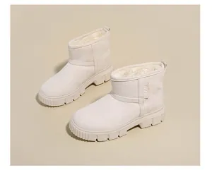 Detailed view of women's beige winter snow boots with warm fuzzy lining and thick soles
