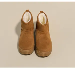 Close-up view of women's suede snow boots with thick white faux fur lining and ridged sole