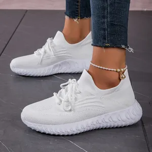 Detailed side view of white breathable flyknit sneakers featuring a secure lace-up design