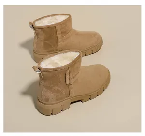 Detail view of women's warm snow boots with thick faux fur lining and suede upper