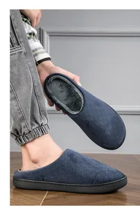 Close-up of cozy navy blue indoor slippers with warm grey faux fur lining for winter