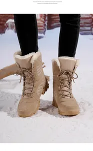 Detailed macro view of women's mid-calf beige snow boots with warm faux fur lining