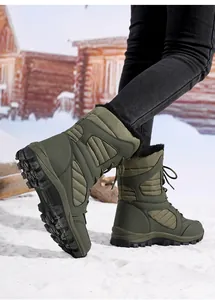 Women's olive green mid-calf snow boots with warm faux fur lining in snowy scene