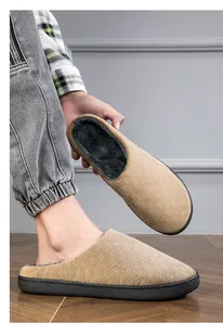 Detailed view of khaki woven home slippers showing the soft faux fur interior lining.