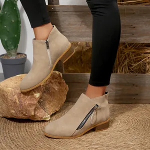 Women's beige pointed toe ankle boots with chunky low heel and double side zippers.