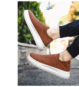 Detail of breathable brown fly-woven slip-on men's shoes with white sole