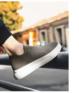 Detail of breathable flyknit men's slip-on sneaker on an urban outdoor background