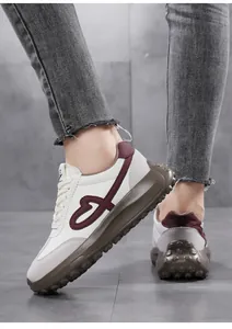 Close-up view of stylish white sneakers with heart embroidery and platform sole