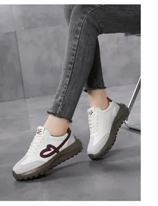 Close-up of stylish off-white platform sneakers with embroidered heart detail.