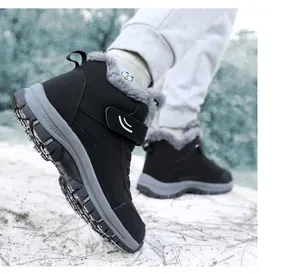 Close-up of black high-top plush snow boots with grey fur lining for outdoor winter use