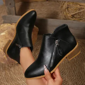 Black faux leather ankle boots with pointed toe and chunky heel featuring side zippers