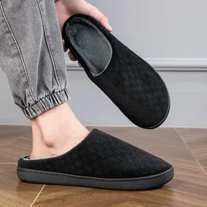 Comfortable black indoor slippers with textured knit upper and soft plush lining