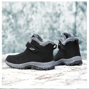 Detail view of black high-top winter boots with warm faux fur lining and velcro strap.