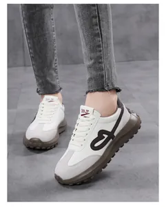 Detailed view of women's vintage white sneakers with heart embroidery and platform sole