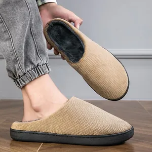 Comfortable tan plush indoor slippers with textured fabric and thick black sole